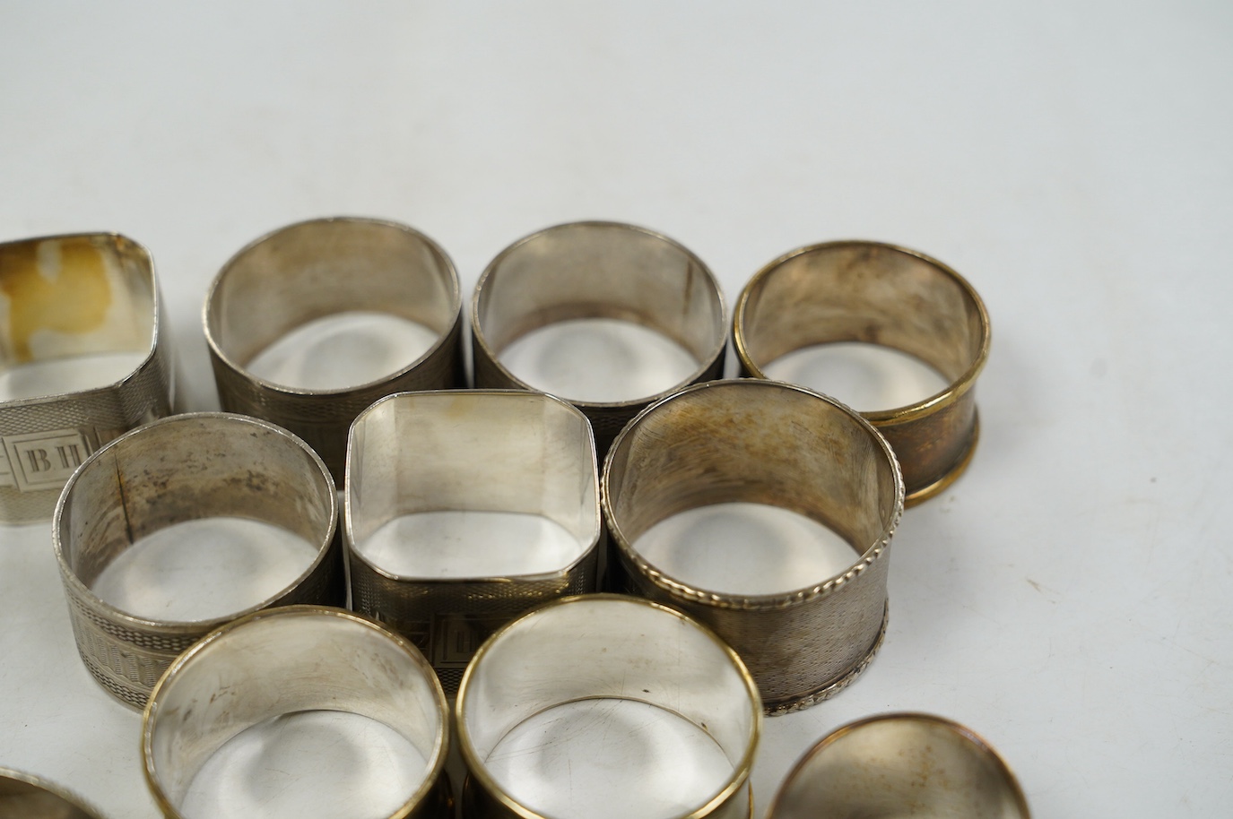 Eight assorted silver napkin rings, including a pair, Birmingham, 1937 and four plated napkin rings. Condition - fair